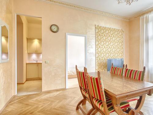 a dining room with a wooden table and chairs at Lyra Apartments in Karlovy Vary