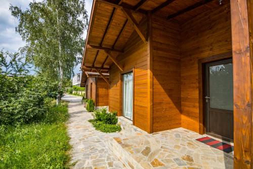 a wooden building with a door on the side of it at Friends Bungalows in Kŭrdzhali