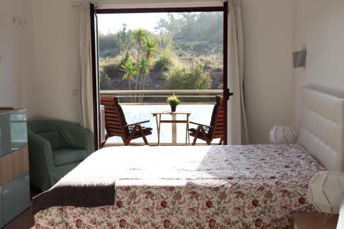 a bedroom with a bed and a view of a pool at Ericeira Sea&Sun Apartment 2 in Ericeira