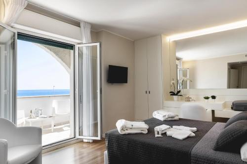 a bedroom with a bed and a view of the ocean at Hotel Sporting in Casalbordino