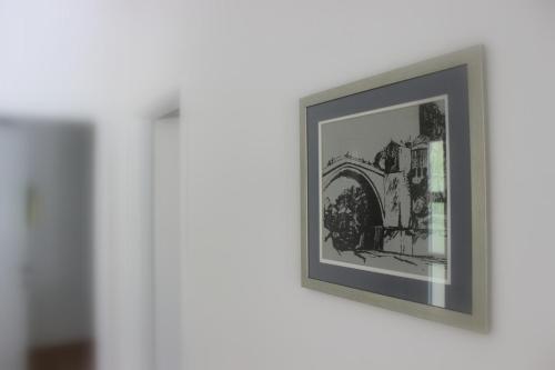 a framed picture of a train on a wall at Villa Mirna in Mostar