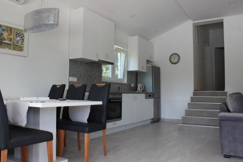 a kitchen and dining room with a table and chairs at Villa Mirna in Mostar