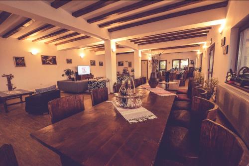 a living room with a wooden table and chairs at Casa Vera, Tudor Vladimirescu in Tulcea