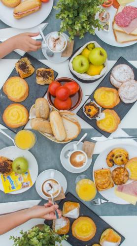 a table filled with plates of food and fruit at Aparthotel Nelva Resort in Cala'n Porter