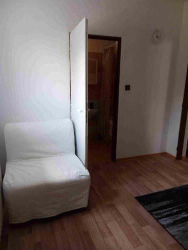 a bedroom with a white bed and a hallway at Ubytování Mája in Liberec