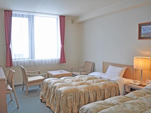 Кровать или кровати в номере Hotel Sunfuraton