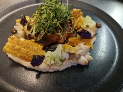 a plate of food with corn and vegetables on it at Genussgasthof Willenshofer in Sankt Kathrein am Hauenstein