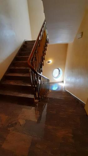 a staircase in a building with a clock on the wall at Hotel Valentino Centro Storico in Orvieto