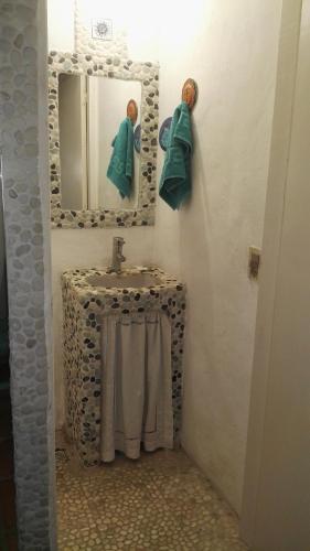 a bathroom with a sink and a mirror at La Escondida in Punta del Este