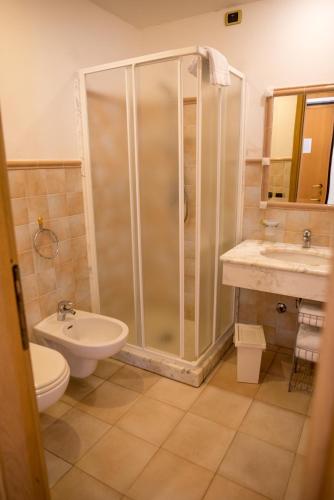 a bathroom with a shower and a toilet and a sink at Riviera Residence in Marina di Pietrasanta