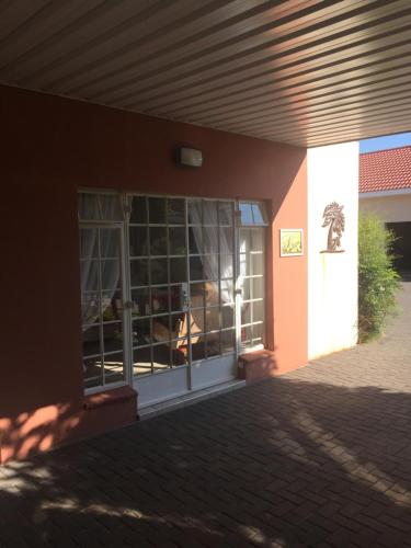 a front door of a building with a fire in the window at Welcome Guest House in Vereeniging
