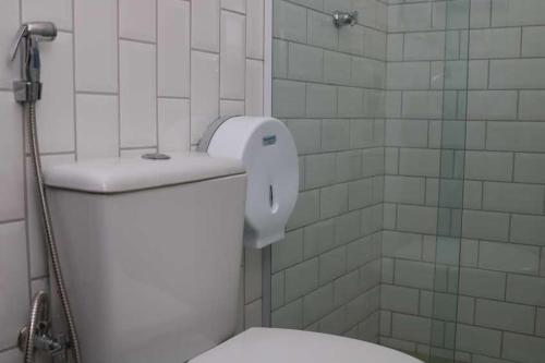 a bathroom with a white toilet and a shower at Sonho de Iracema Hostel Boutique in Fortaleza