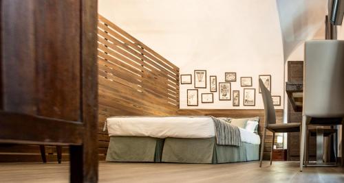 a bedroom with a bed with a wooden headboard at La Canonica - charming self-catering apartments in Nizza Monferrato in Nizza Monferrato