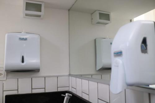 a bathroom with a sink and two mirrors at Sonho de Iracema Hostel Boutique in Fortaleza
