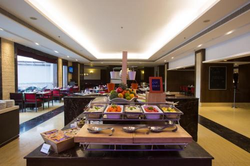 a buffet line in a hotel with food on it at Golden Tulip Chandigarh, Panchkula in Chandīgarh