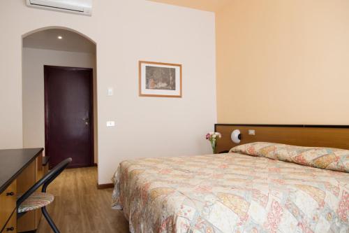 a bedroom with a bed and a dresser in it at Aries in Lesa