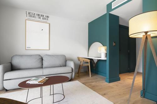 a living room with a couch and a table at Black Bass Hotel in Sévrier