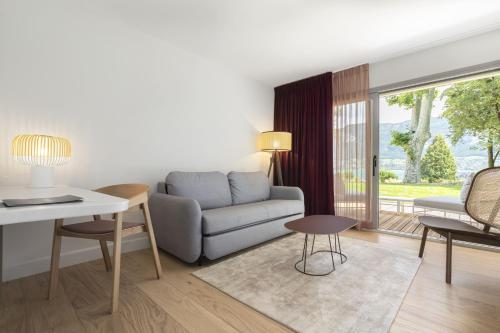 a living room with a couch and a table at Black Bass Hotel in Sévrier