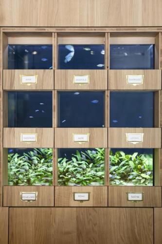 a wooden cabinet with four drawers with glass doors at Black Bass Hotel in Sévrier
