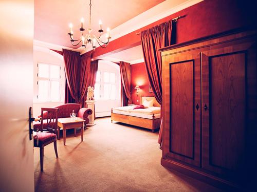 a bedroom with a bed and a room with a table at Trip Inn Hotel Der Adelshof in Schwäbisch Hall