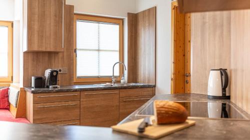 a kitchen with a counter with a loaf of bread on a cutting board at Apartment Neuper in Bad Mitterndorf