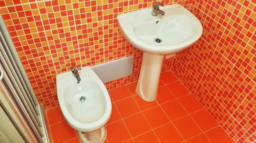 a bathroom with a sink and a toilet at Casa Gentile Caruso in Torrenova