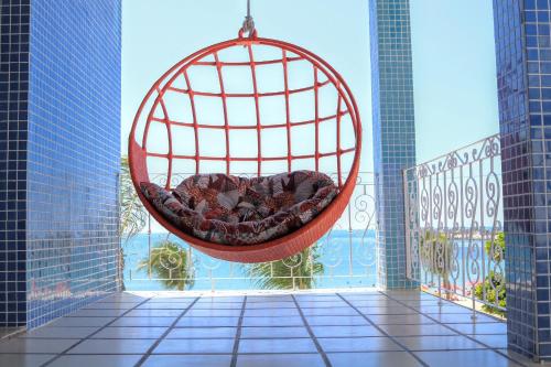a hammock hanging from a balcony with a view at Sonho de Iracema Hostel Boutique in Fortaleza