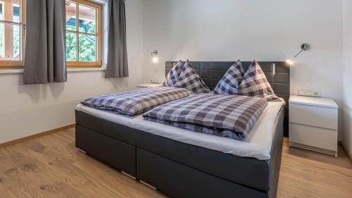 a bed with two pillows on it in a bedroom at Apartment Neuper in Bad Mitterndorf