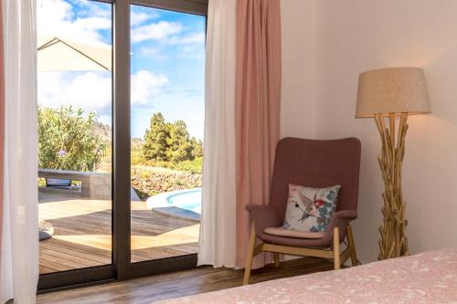 a bedroom with a sliding glass door leading to a deck at BLUE Casa by VILLA HAHN in Puntagorda