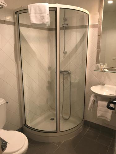 a bathroom with a shower and a toilet and a sink at Le Vieux Logis de Clam in Clam