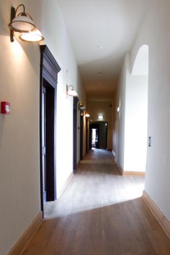 an empty hallway with white walls and wood floors at Zamek Golubski in Golub-Dobrzyń