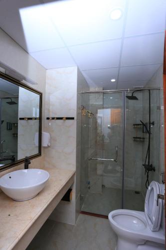 a bathroom with a sink and a shower and a toilet at SONG ANH HOTEL in Can Tho