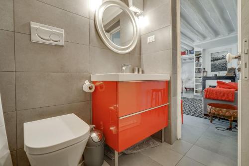une salle de bain avec toilettes, lavabo et miroir dans l'établissement Saint Germain dès Pres Paris VI° - Unit 003, à Paris