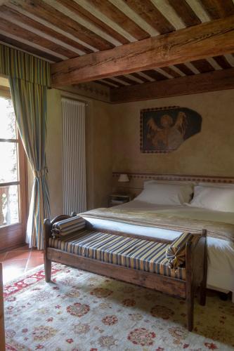 a bed in a bedroom with a wooden ceiling at Relais Mont Blanc Hotel & Spa in La Salle