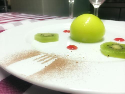 a white plate with a green apple and a fork at Chabanettes Hotel & Spa in Auzelles