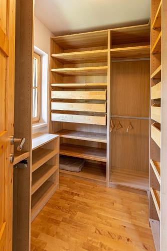 a walk in closet with wooden shelves at Apartment Neuper in Bad Mitterndorf