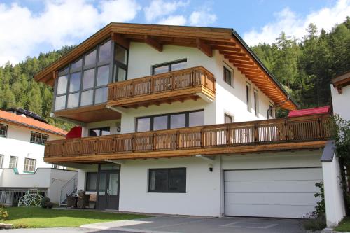 a house with a balcony on top of it at Ferienwohnung Mattle in Jerzens