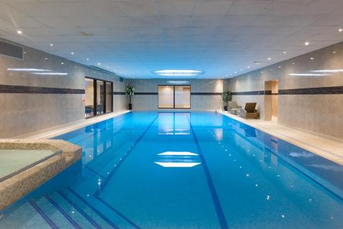
a swimming pool with a blue floor and blue walls at Connaught Lodge in Bournemouth
