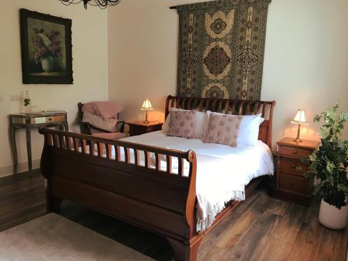 a bedroom with a bed and two tables with lamps at The Happy Pig in Kenmare