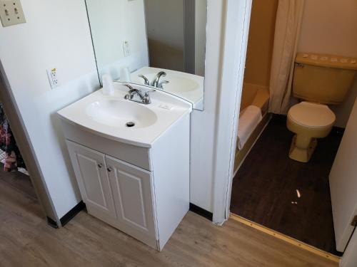 a bathroom with a sink and a toilet at Rainbow Motel in Swift Current