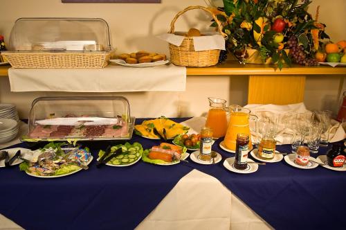 a table with plates of food on a blue table cloth at Sea-View Zum Sperrgebiet in Lüderitz