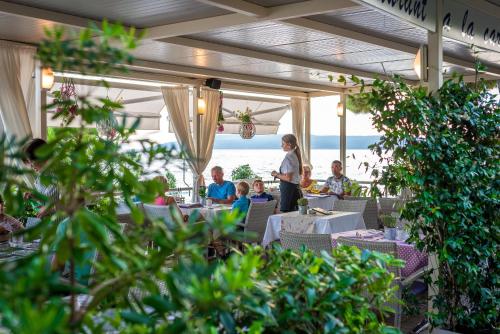 a group of people sitting at tables in a restaurant at Hotel Maritimo in Makarska
