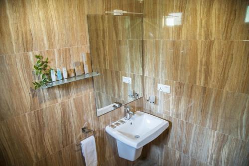 a bathroom with a sink and a mirror at Wadula Safari - Yala in Kataragama