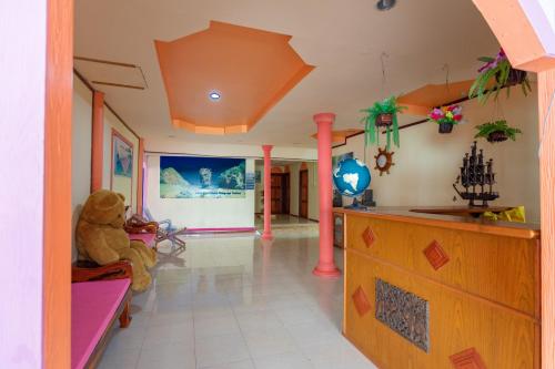a teddy bear sitting on a couch in a room at Jamesbond Bungalow Koh Panyee in Ko Panyi