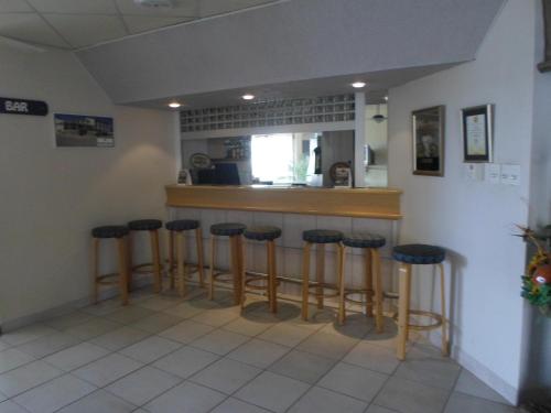 a bar with four stools in a room at Sea-View Zum Sperrgebiet in Lüderitz