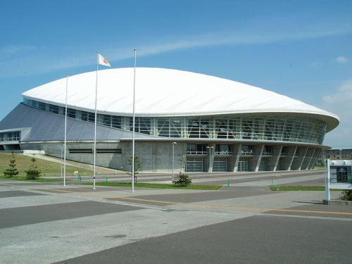 a large round building with a white roof at Hotel Wing International Sapporo Susukino in Sapporo