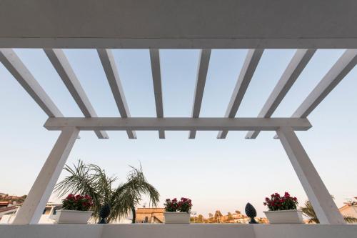 a glass roof with potted plants on a balcony at La Scala Suite in Realmonte