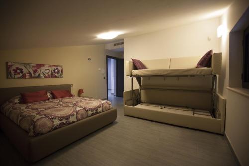 a bedroom with two bunk beds in a room at La Cartolina del Sannio in Campolattaro