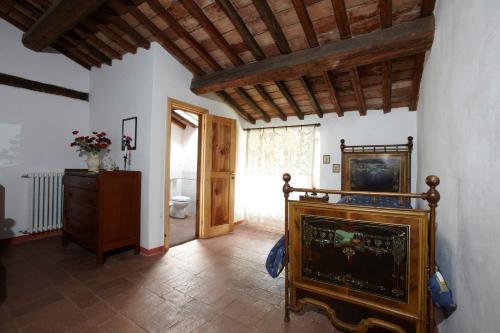 a living room with a fireplace and a bathroom at Casina Della Burraia in Subbiano