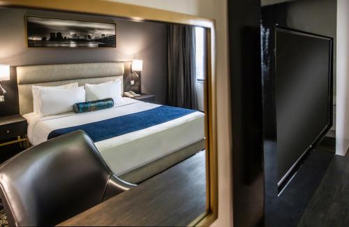 a hotel room with a bed and a mirror at Mövenpick Hotel Ikoyi Lagos in Lagos